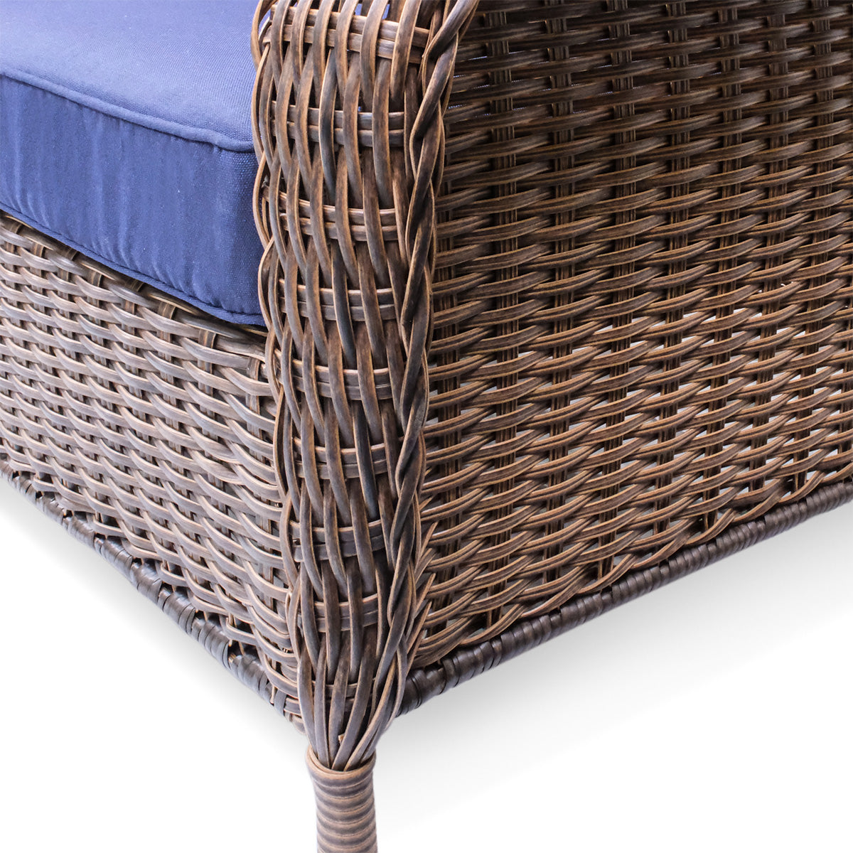 Close-up view of the chair leg on the Cambridge sectional, highlighting the sturdy powder-coated steel frame and all-weather wicker design.