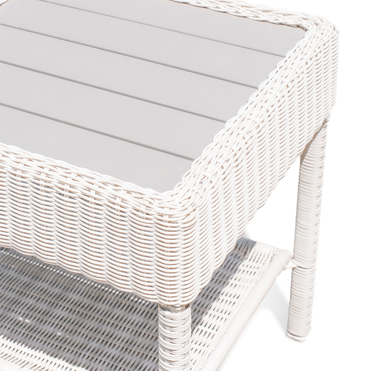 Upper side view of Park Meadows Wicker Outdoor End Table showing slatted top, all-weather resin wicker, and built-in shelf, Oakville, ON.