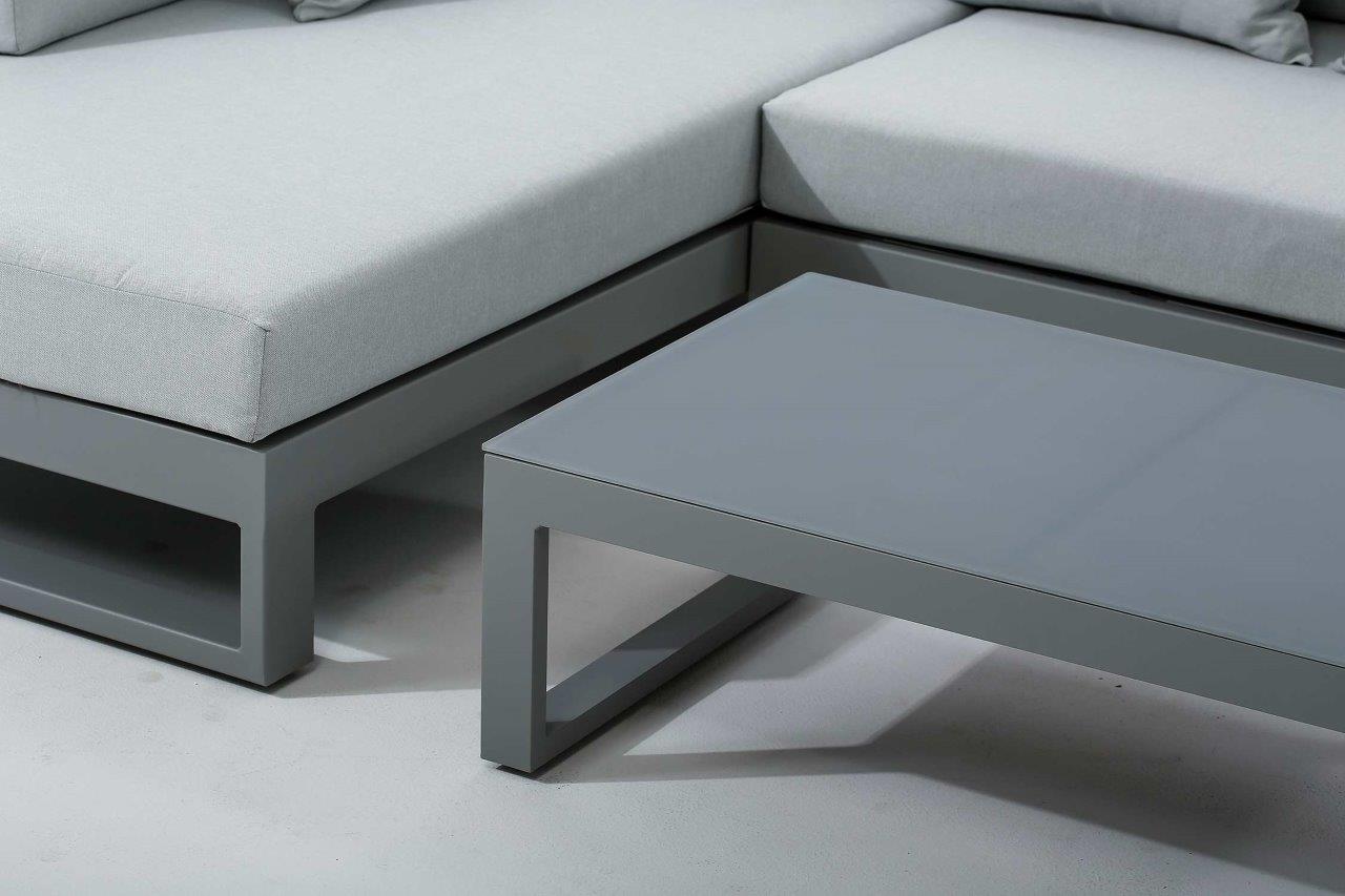 Close-up view showcasing the sectional seating and frosted tempered glass coffee table, highlighting the sleek, modern design.