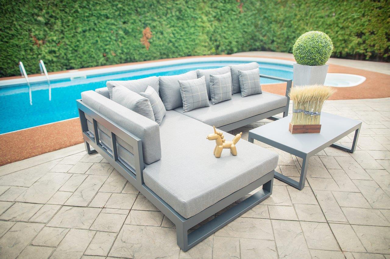 Side-angle view showcasing the sleek aluminum frame and teak wood armrests, offering a modern aesthetic by the poolside.