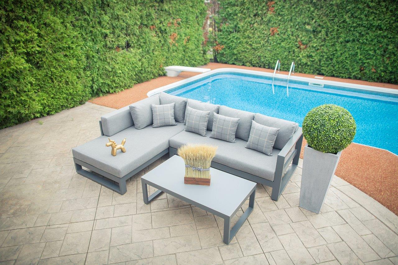 Full setup displayed by the poolside, showcasing the modern sectional and frosted glass coffee table in a luxurious outdoor setting.